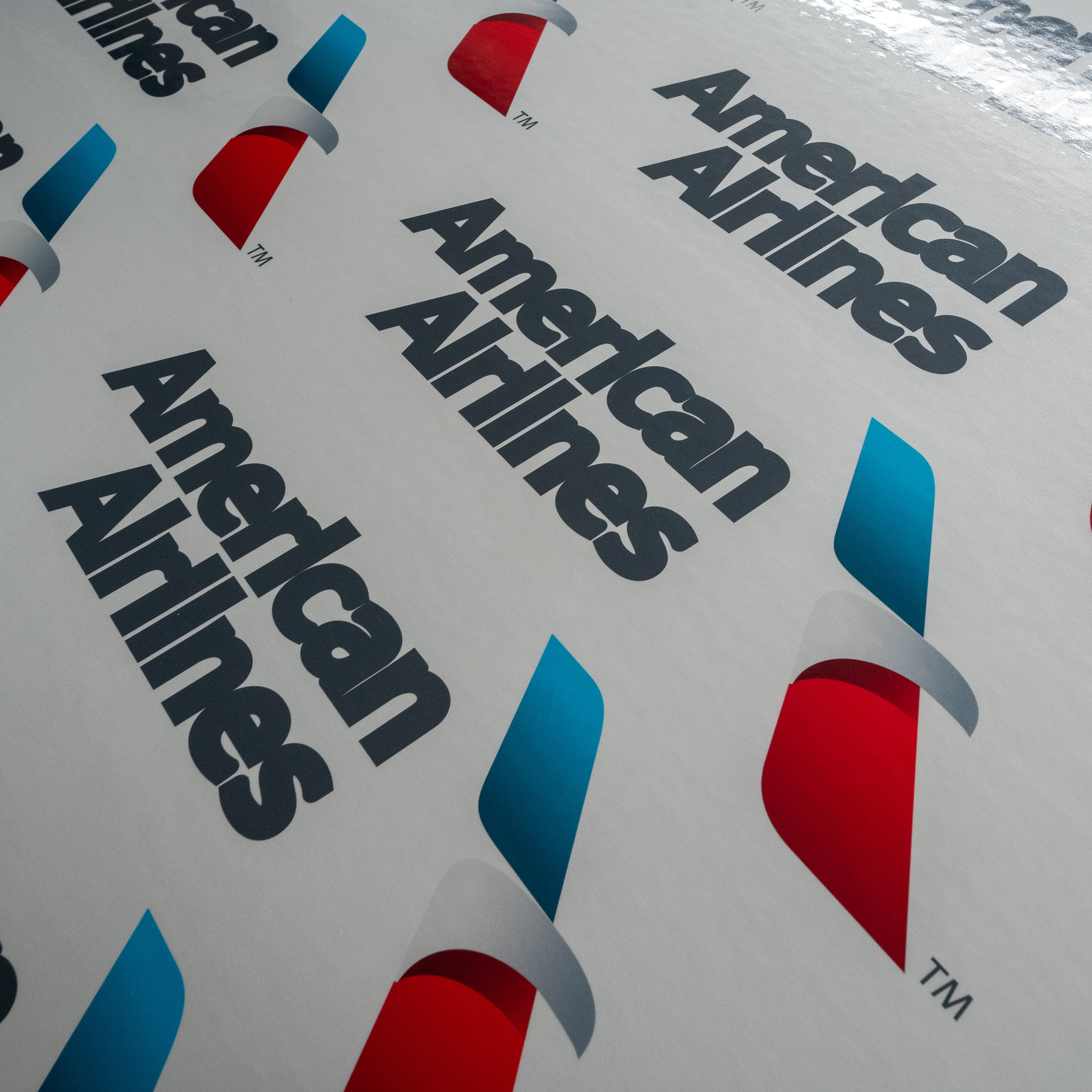 Multiple American Airlines logo stickers arranged on a surface